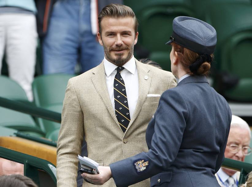 Smette di piovere e arriva... David Beckham al Royal Box. Reuters